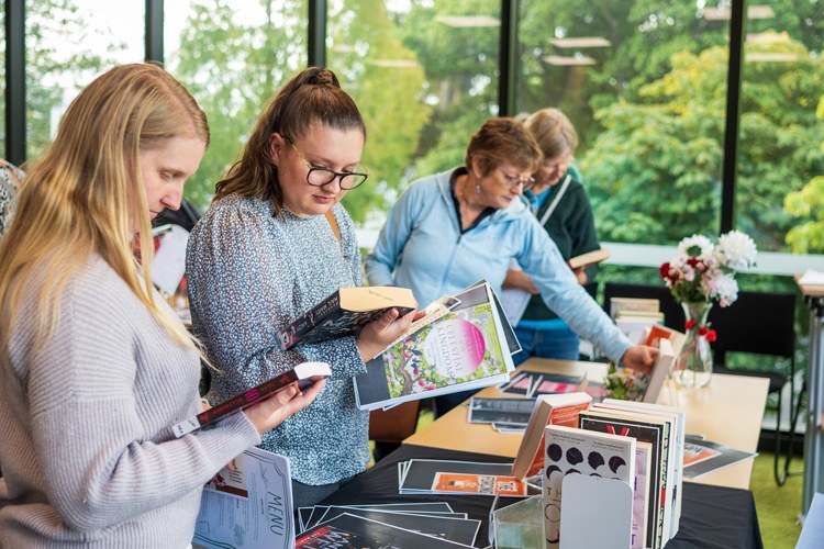 women reading the back of books